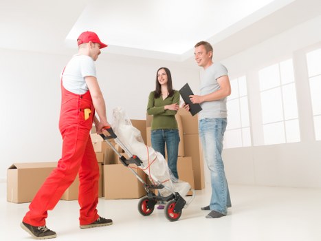 Packed moving boxes and furniture ready for removals in Sipson