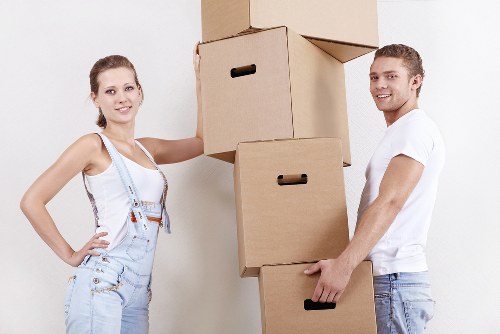 Packed boxes and furniture ready for collection by movers